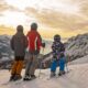 Famiglia sugli sci in montagna che guarda il paesaggio